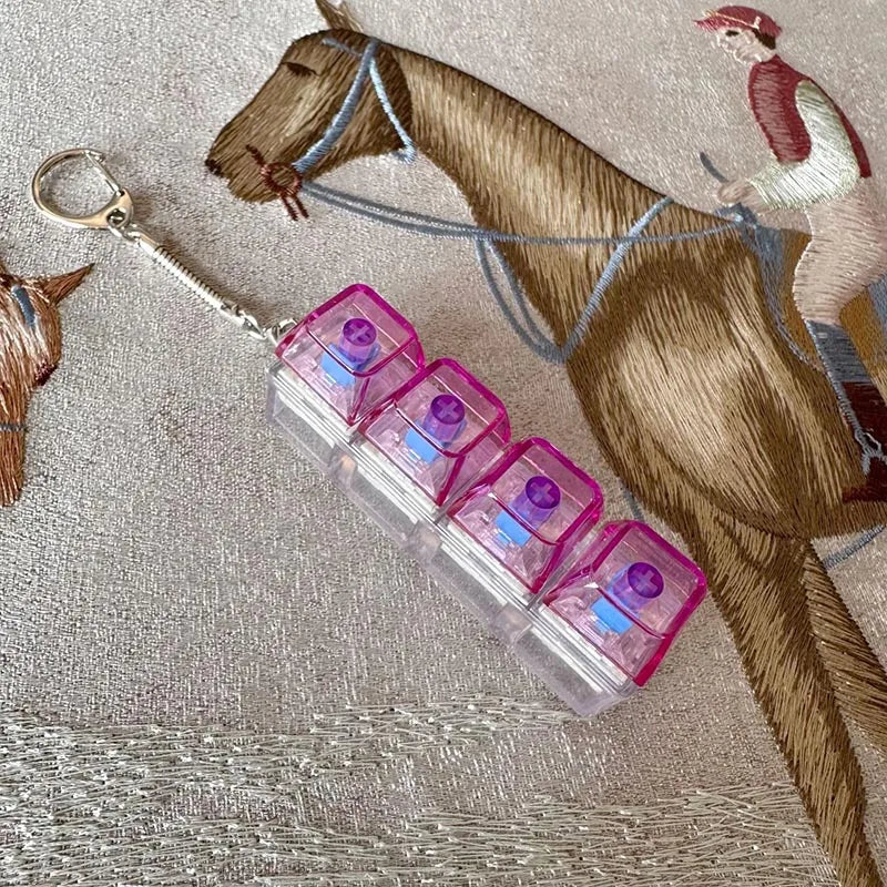 A brown horse figurine with a light-up keyboard keychain attached to its bridle.