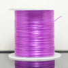A spool of purple elastic cord used for beading and jewelry making.