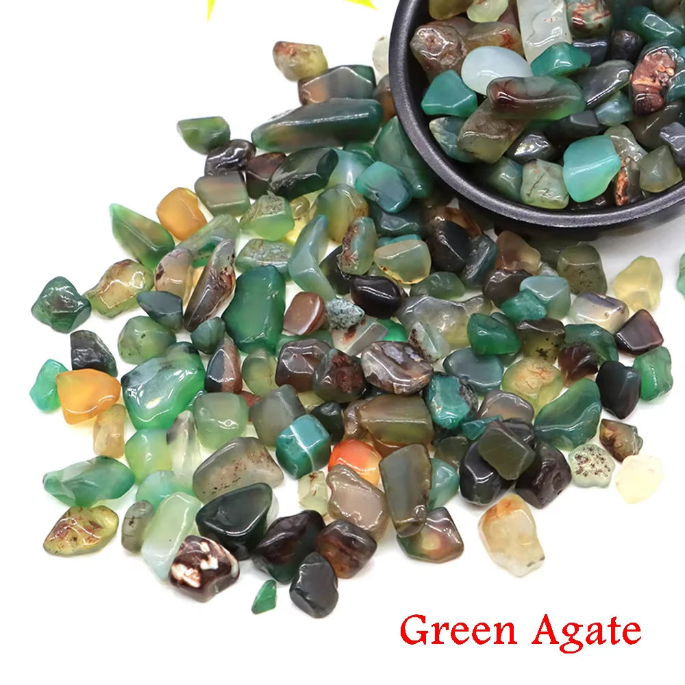 A collection of green agate tumbled crystal stone chips in various shades and sizes.
