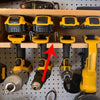 A yellow belt clip hook bit holder for cordless drills is displayed in a wooden box.