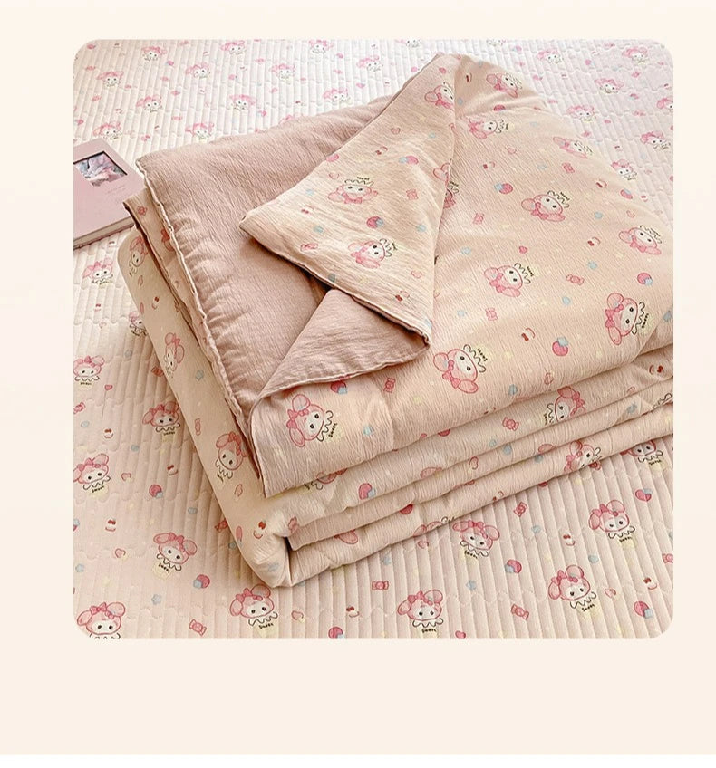 A stack of light pink quilt fabric featuring a cartoon pattern of pink animals on a white background.