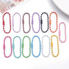 A collection of 20 colorful ball bead chains in various colors and lengths laid out on a white surface.