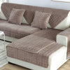 A beige velvet sofa cushion cover set featuring quilted fabric and white trim on a modern sofa.
