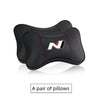 A pair of black PU leather car headrest pillows and seatbelt shoulder pads