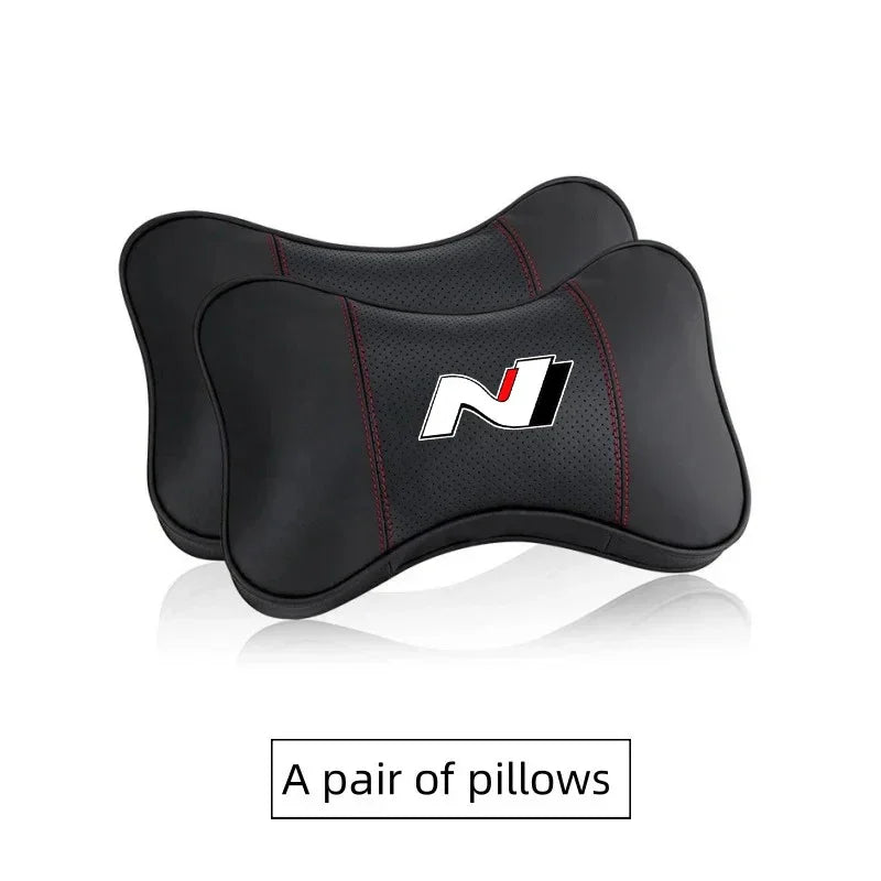 A pair of black PU leather car headrest pillows and seatbelt shoulder pads