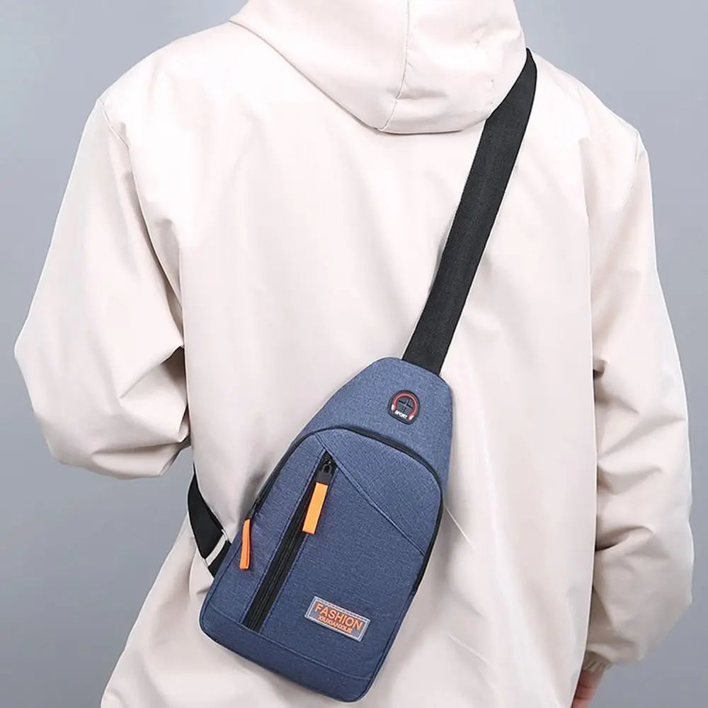 A beige hooded jacket is shown wearing a navy blue Oxford canvas crossbody chest bag with multiple pockets.