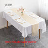 Elegant satin table runner in beige and white for a dining table setting.