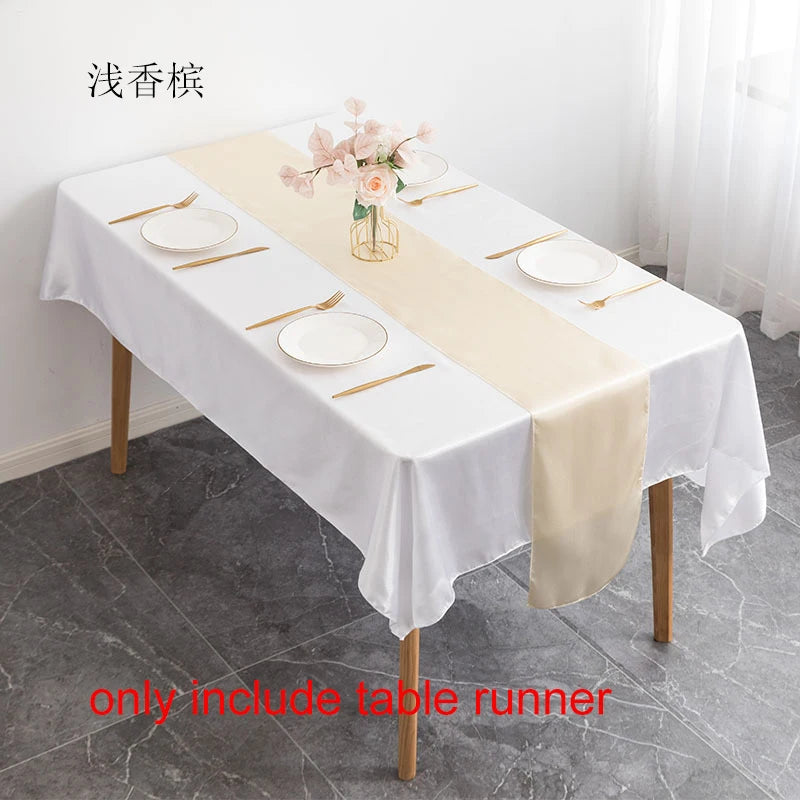 Elegant satin table runner in beige and white for a dining table setting.