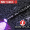A black portable UV flashlight is shown being used in the rain, highlighting its water resistance.