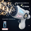A white electric bubble gun with 32 holes is shown firing bubbles against a dark background.
