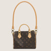 A brown synthetic leather handbag with a gold-toned strap and flap closure.