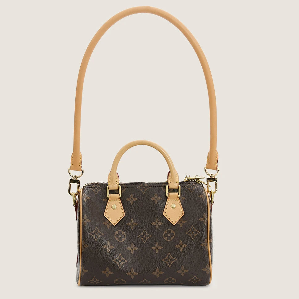 A brown synthetic leather handbag with a gold-toned strap and flap closure.
