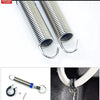 A close-up view of a shiny metal spring used for an adjustable car trunk lift, showing the coil and hook end.