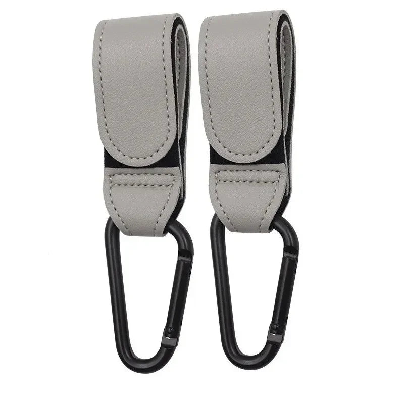 A pair of gray PU leather stroller hooks with swivel clasps.