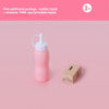 A pink bottle with a white cap and a small beige box is shown on a light pink background.