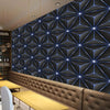 Modern interior wall featuring a dark gray geometric pattern wallpaper above a leather bench and wooden tables.