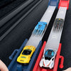A hand is launching a blue die-cast racing car on a red catapult track set.