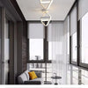 Modern clover LED ceiling light fixture installed above a large window and glass door.