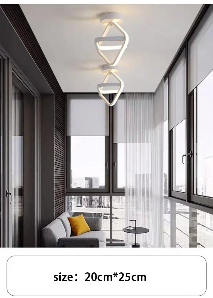 Modern clover LED ceiling light fixture installed above a large window and glass door.