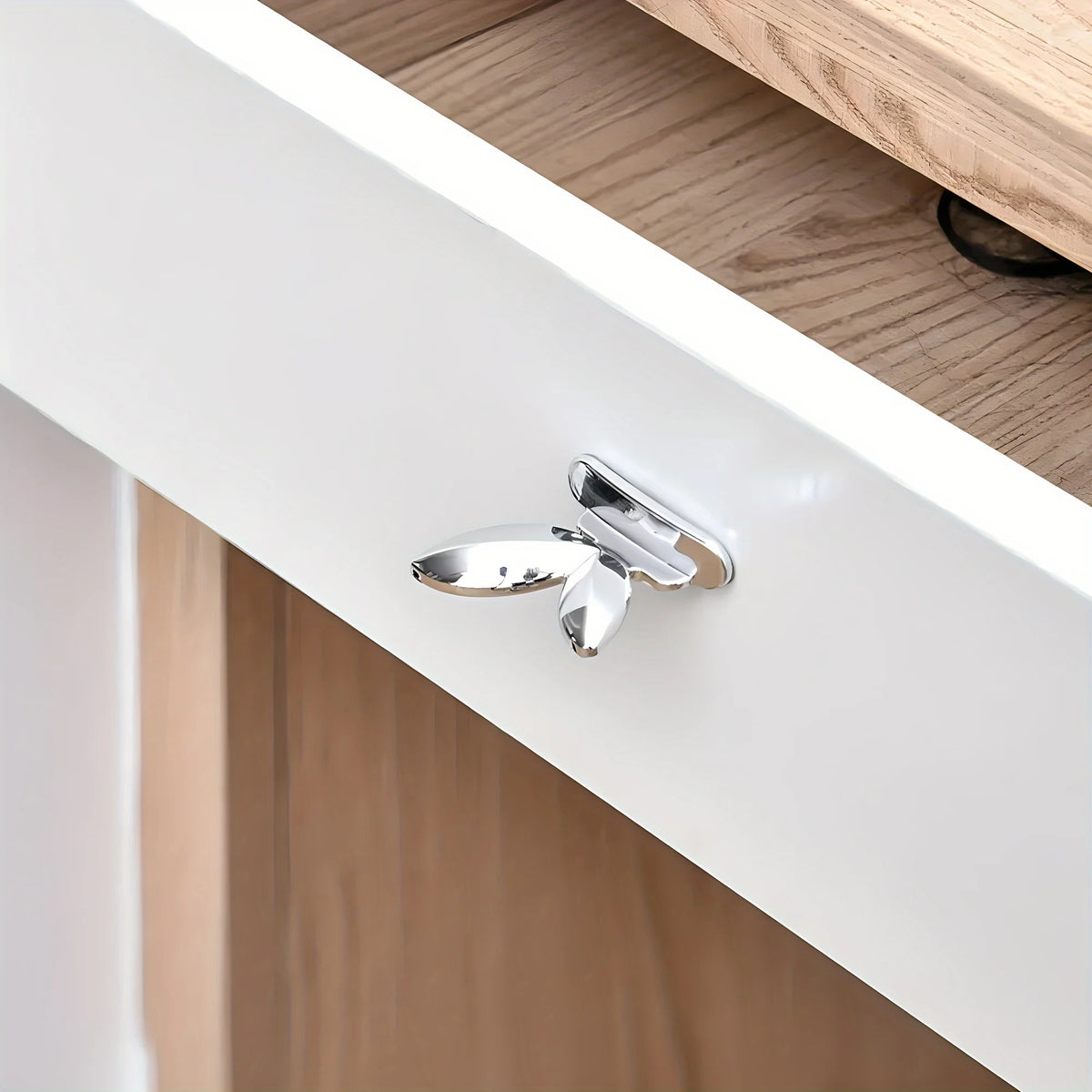 A silver touch-free toilet seat lifter with a flush button mounted on a white ceramic toilet seat.
