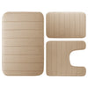A set of three beige plush memory foam bath mats with ribbed non-slip backing.