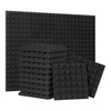A stack of black pyramid acoustic foam panels.
