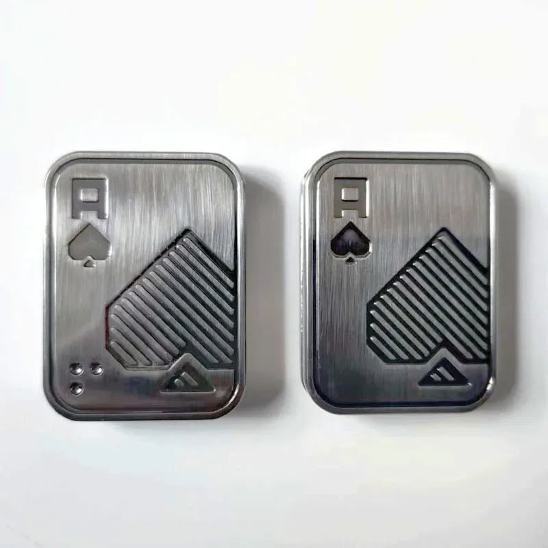 Two silver metal cards featuring a spade symbol and a triangle design for stress relief