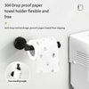 A black towel holder with a drop-proof design is mounted on a white wall, next to a white towel and a white bathroom dispense