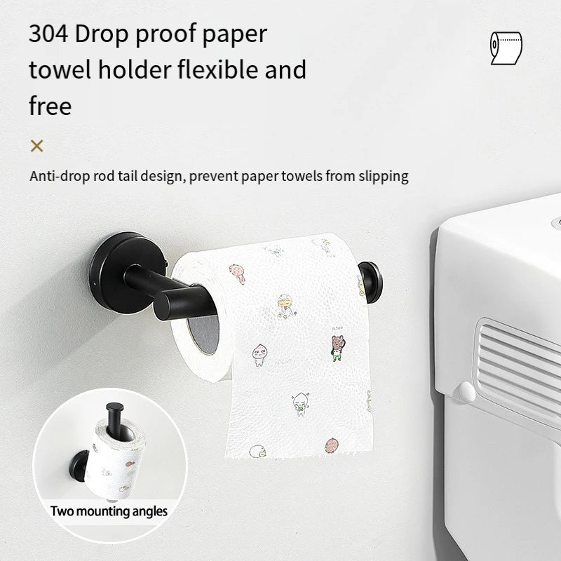 A black towel holder with a drop-proof design is mounted on a white wall, next to a white towel and a white bathroom dispense