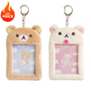 A pair of Rilakkuma plush ID card holders and keychains, one in beige and one in white.