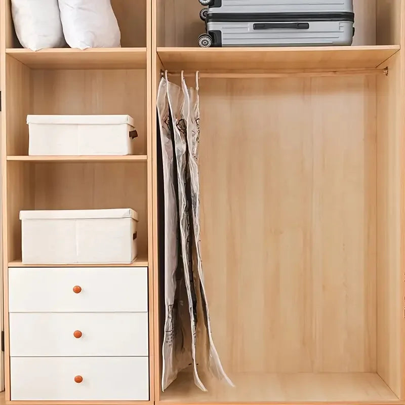 A wooden storage cabinet with shelves holding white storage boxes and a hanging compression bag.
