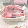 A pink polka dot shell pencil case with multiple compartments is shown open, displaying various pens and small items.