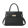 A black leather handbag with a gold-toned clasp and matching coin purse.