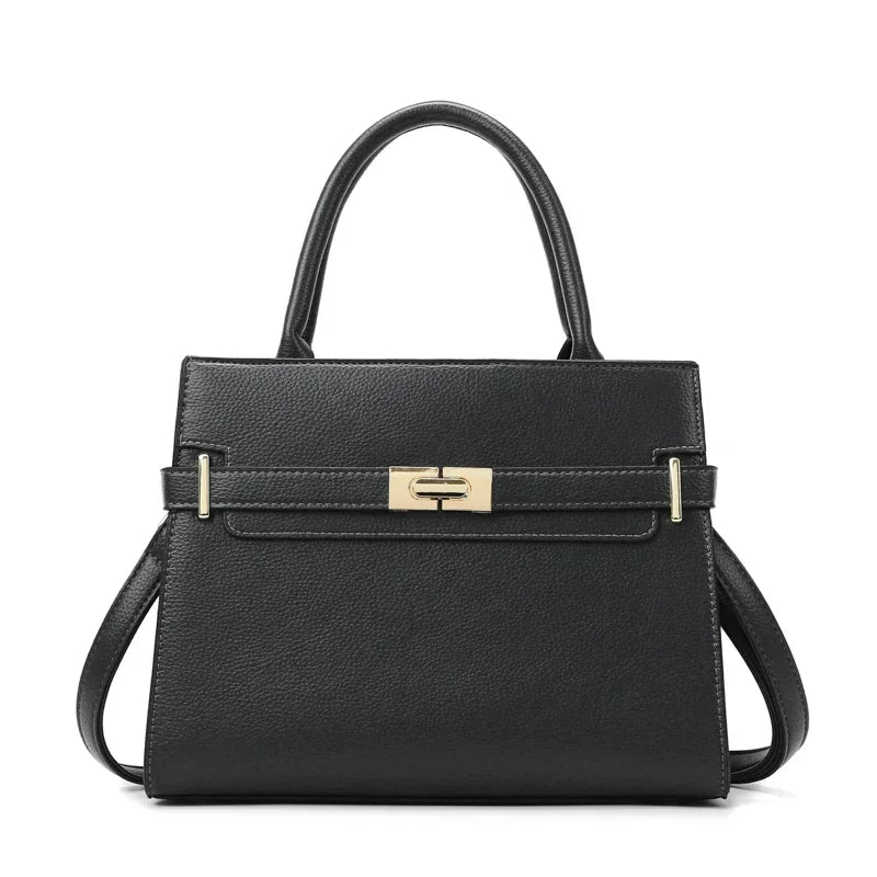 A black leather handbag with a gold-toned clasp and matching coin purse.