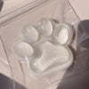 A clear plastic bag contains a silicone cat paw squeeze toy for stress relief and fidgeting.