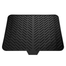 Black silicone dish drying mat with a built-in drain lip for drying dishes.