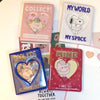A collection of three mini photo albums titled Collect My World and Cool Kids featuring heart-shaped covers.