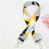 A patterned fabric strap featuring yellow and gray geometric shapes for an elegant crossbody bag.