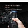 A hand is holding a black PU leather car gear shift cover, demonstrating its non-slip grip.