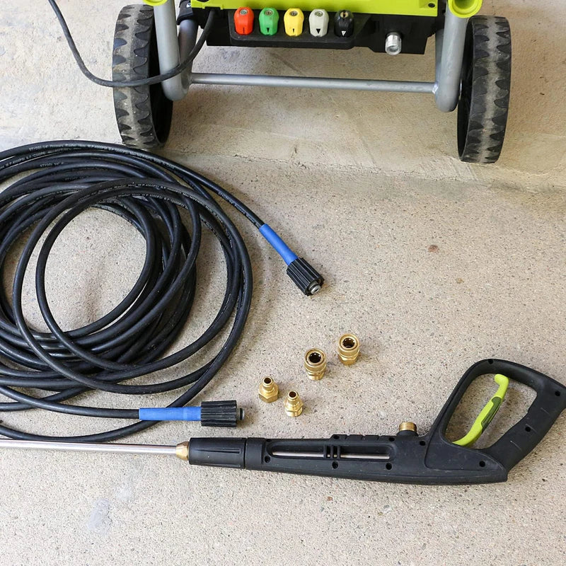 A black pressure washer adapter kit with a quick connect nozzle and a brass fitting is shown next to a yellow and gray cart.