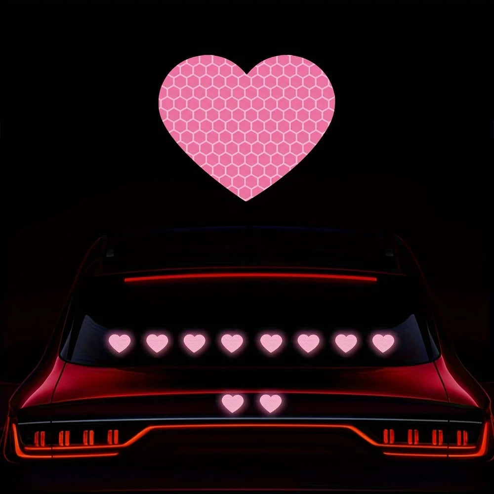Pink honeycomb heart stickers floating above a red car with glowing red accents.