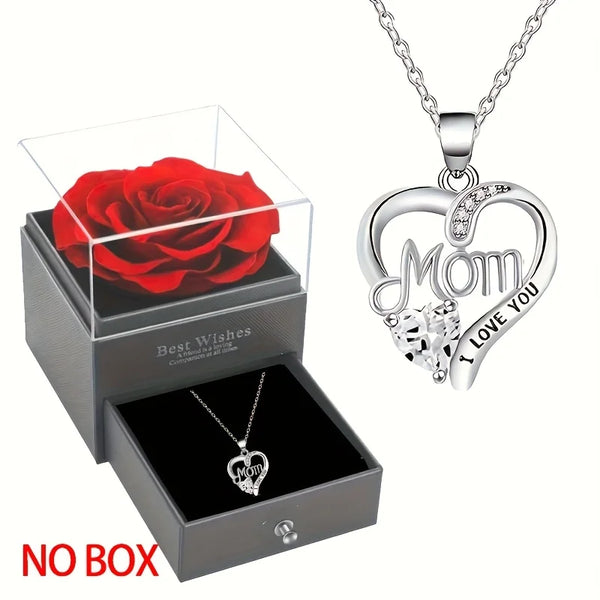 Silver heart pendant necklace with a rose and a red rose flower displayed in a box.