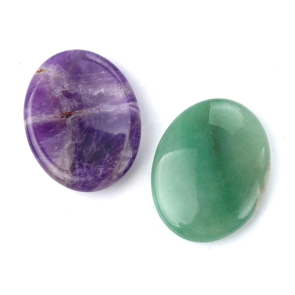 A pair of oval crystal stones, one purple and one green, used for thumb worry or massage.