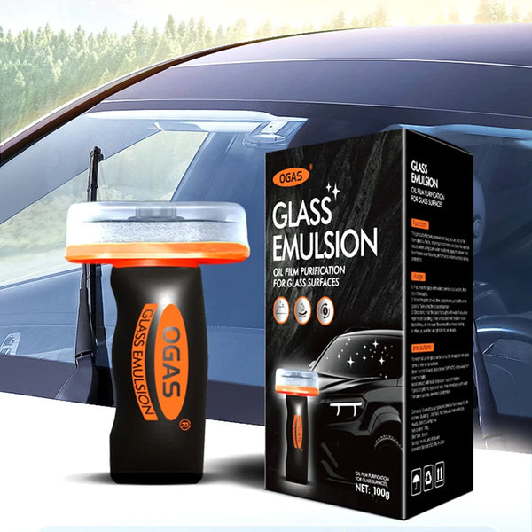 A black bottle of Glass Emulsion oil film purification brush is shown next to its packaging box in front of a car window.