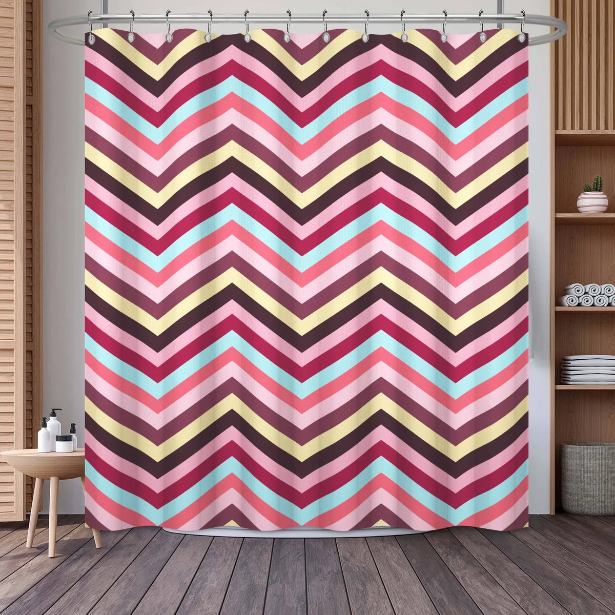 A shower curtain featuring a geometric chevron stripe pattern in shades of pink, red, blue, and yellow.