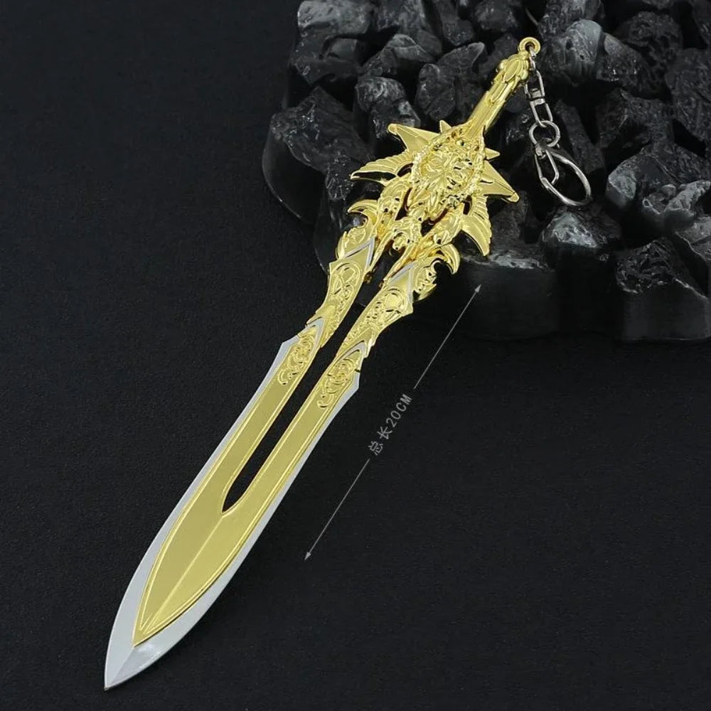 A detailed gold-colored metal sword keychain featuring a stylized blade and hilt, displayed against a dark background.