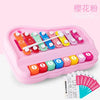 A pink Montessori musical xylophone piano set with colorful wooden bars and numbered keys for toddlers.