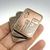 A hand holds a metal poker card with a fingertip design, featuring a king and heart symbols.