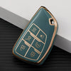 A teal and gold durable TPU car key fob cover with various buttons shown on a dark surface.