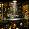 A black willow wood wishing stick displayed in a glass cabinet with various collectible figures.